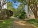 Scenic yard featuring an extensive mulch walkway, lush grass, and mature trees for a private and tranquil setting at 308 Sunset Creek Cir, Chapel Hill, NC 27516