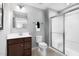 A well-lit bathroom featuring a glass shower, a brown vanity, and neutral walls at 35 Boots Ridge Way, Franklinton, NC 27525