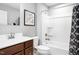 Clean bathroom with tub and shower, brown vanity with white sink and chrome fixtures at 35 Boots Ridge Way, Franklinton, NC 27525