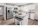 Bright kitchen boasts stainless steel appliances, granite countertops, and an island with stool seating at 35 Boots Ridge Way, Franklinton, NC 27525