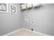 Neutral-colored laundry room with tile floors, artwork, and wire shelving for storage at 35 Boots Ridge Way, Franklinton, NC 27525