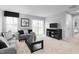 Bright living room complete with a sofa, modern decor, and large sliding glass doors at 35 Boots Ridge Way, Franklinton, NC 27525