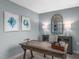 Stylish office featuring blue walls, a wood desk, and modern decorations at 35 Boots Ridge Way, Franklinton, NC 27525