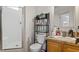 Bathroom with a walk-in shower, toilet, and vanity with a sink and storage at 3604 Stagecoach Rd, Durham, NC 27713