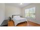 Bedroom with a bed, wood flooring, a ceiling light, and natural light from the window at 3604 Stagecoach Rd, Durham, NC 27713