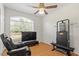 Bedroom with a ceiling fan, wood flooring, natural light, and exercise equipment at 3604 Stagecoach Rd, Durham, NC 27713