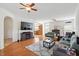 Open-concept living room features hardwood floors and a ceiling fan at 3604 Stagecoach Rd, Durham, NC 27713