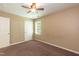 Neutral colored bedroom featuring carpeted floors, closet, a window with natural light, and a ceiling fan at 3819 Valleydale Dr, Durham, NC 27703