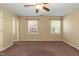 Well-lit bedroom featuring neutral colored walls, two windows with natural light, and a ceiling fan at 3819 Valleydale Dr, Durham, NC 27703
