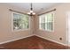 Well-lit dining area with hardwood floors and two bright windows at 3819 Valleydale Dr, Durham, NC 27703