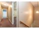 Hallway with carpet and wall paint that transitions to a bathroom and bedroom area in a residential home at 3819 Valleydale Dr, Durham, NC 27703