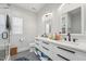 Bathroom featuring a dual sink vanity, tiled floors, and modern fixtures at 3908 Booker Ave, Durham, NC 27713