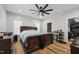 Bedroom features a dark wood bed frame, hardwood floors, ceiling fan, and plenty of natural light at 3908 Booker Ave, Durham, NC 27713