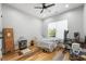 Neutral bedroom with wood-look floors, ceiling fan, natural light, and work space at 3908 Booker Ave, Durham, NC 27713