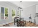 Dining area with modern light fixture, wood table and bench, and natural light at 3908 Booker Ave, Durham, NC 27713