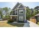 Charming two-story home with gray siding, white trim, covered porch, and a concrete driveway at 3908 Booker Ave, Durham, NC 27713