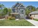 Charming two-story home with gray siding, white trim, covered porch, and a well-manicured front yard at 3908 Booker Ave, Durham, NC 27713