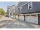 Modern three-car garage with white doors and black hardware at 3908 Booker Ave, Durham, NC 27713