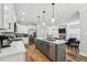 Modern kitchen with stainless appliances, white cabinets and view to living room at 3908 Booker Ave, Durham, NC 27713