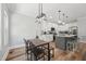 Modern kitchen with gray island, white cabinets, stainless steel appliances, and dining area at 3908 Booker Ave, Durham, NC 27713