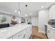 Open concept kitchen with quartz countertops and view of the living room at 3908 Booker Ave, Durham, NC 27713