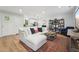 Cozy living room with white couch, colorful rug, and contemporary decor at 3908 Booker Ave, Durham, NC 27713