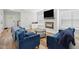 Living room with fireplace, television, hardwood floors, and view to entry at 3908 Booker Ave, Durham, NC 27713