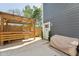 Outdoor patio with a wooden pergola, privacy fence, and an exterior door to the home at 3908 Booker Ave, Durham, NC 27713