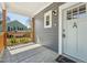 Covered porch with painted concrete and painted wood railing leading to the door at 3908 Booker Ave, Durham, NC 27713