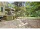 Landscaped backyard area with deck and stairs leading to screened in porch at 4 W Bridlewood Trl, Durham, NC 27713