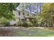 Large backyard with mature trees and established landscaping, including a deck and screened porch at 4 W Bridlewood Trl, Durham, NC 27713