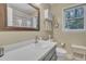 Clean bathroom with a white counter, sink, and beige walls at 4 W Bridlewood Trl, Durham, NC 27713