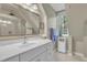 Bright bathroom with a white vanity, large mirror, and shower at 4 W Bridlewood Trl, Durham, NC 27713