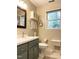 Bathroom features a vanity with storage, a mirror, and a window at 4 W Bridlewood Trl, Durham, NC 27713