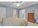 Neutral bedroom featuring a bed, wood dresser, and ensuite bathroom at 4 W Bridlewood Trl, Durham, NC 27713