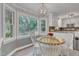 Bright breakfast nook featuring a wooden table with chairs and a large window overlooking the outdoors at 4 W Bridlewood Trl, Durham, NC 27713
