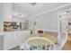 Charming breakfast nook with a light wood table, white chairs, and an open design at 4 W Bridlewood Trl, Durham, NC 27713
