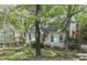 Charming two-story home with a well-maintained lawn and mature trees in front at 4 W Bridlewood Trl, Durham, NC 27713