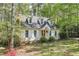 Charming cottage-style home with dormer windows, white shutters, and a landscaped front yard at 4 W Bridlewood Trl, Durham, NC 27713