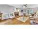 Cozy living room features a fireplace, hardwood floors, and access to the outdoors at 4 W Bridlewood Trl, Durham, NC 27713