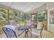 Relaxing screened porch with wood floors, patio furniture, string lights, and backyard view at 4 W Bridlewood Trl, Durham, NC 27713