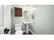 Powder room with pedestal sink, modern toilet, cabinet, decorative mirror, and modern lighting at 4112 Riverport Rd, Raleigh, NC 27616