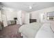 Bright bedroom with desk and computer, featuring carpeted floor, ceiling fan, and neutral decor at 4112 Riverport Rd, Raleigh, NC 27616