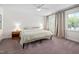 Spacious bedroom featuring a large bed, windows with curtains, neutral carpet, and a ceiling fan at 4112 Riverport Rd, Raleigh, NC 27616