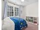 bedroom with ceiling fan, space themed bedding, and toy storage shelves at 4112 Riverport Rd, Raleigh, NC 27616