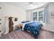 Bright bedroom with ceiling fan, blue space themed bedding and view of backyard at 4112 Riverport Rd, Raleigh, NC 27616