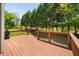 Relaxing on this wooden deck offers tranquil views of the lush backyard and mature trees at 4112 Riverport Rd, Raleigh, NC 27616