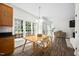 Bright eat-in kitchen with a wood table and chairs, large windows, wood cabinets, and easy access to the living room at 4112 Riverport Rd, Raleigh, NC 27616