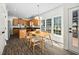 Eat-in kitchen with wood cabinets, black countertops, wood table and chairs, and plenty of natural light at 4112 Riverport Rd, Raleigh, NC 27616