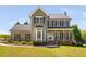 Charming two-story home featuring an inviting front porch and bay window at 4112 Riverport Rd, Raleigh, NC 27616
